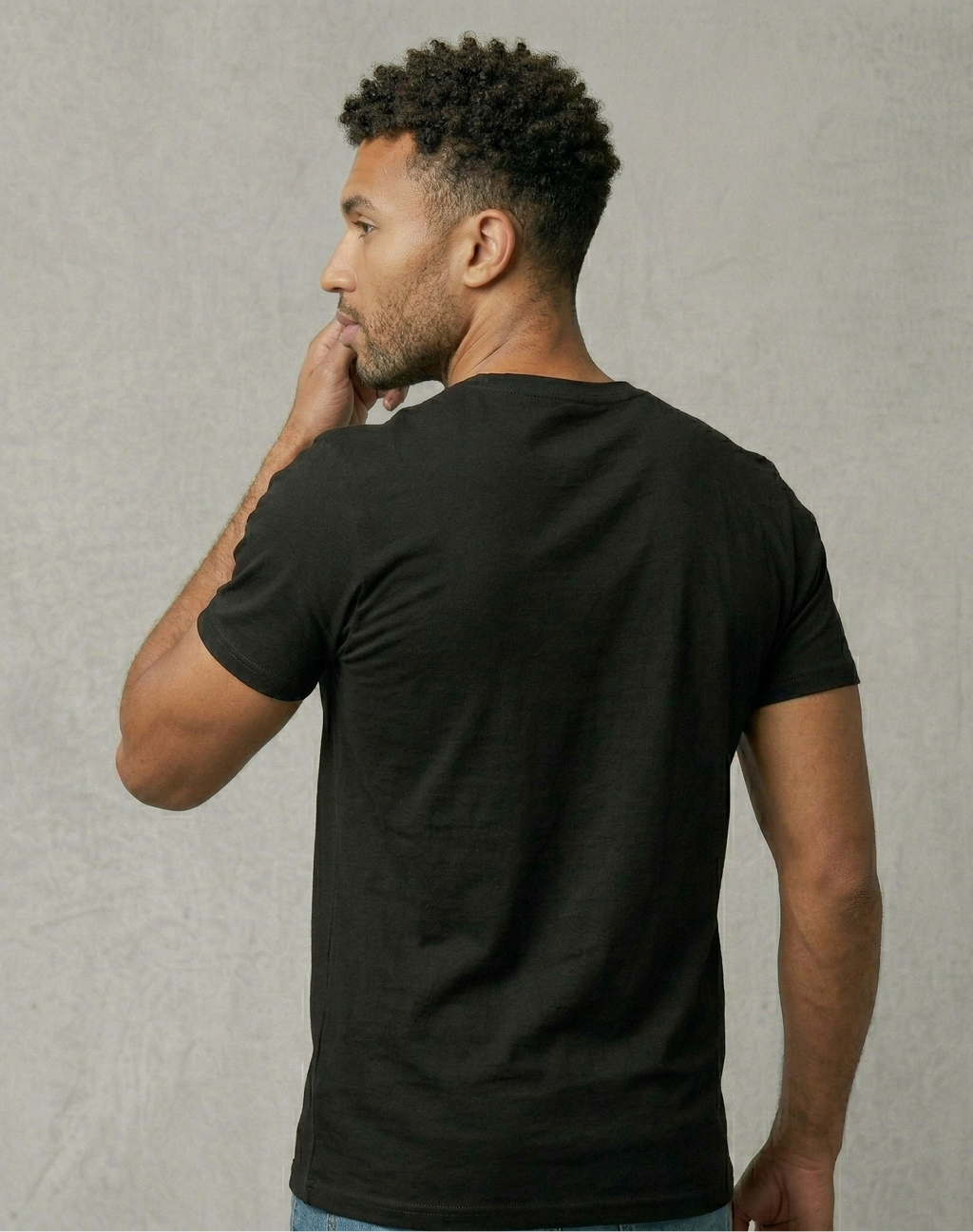 Man wearing a black t-shirt against a plain background