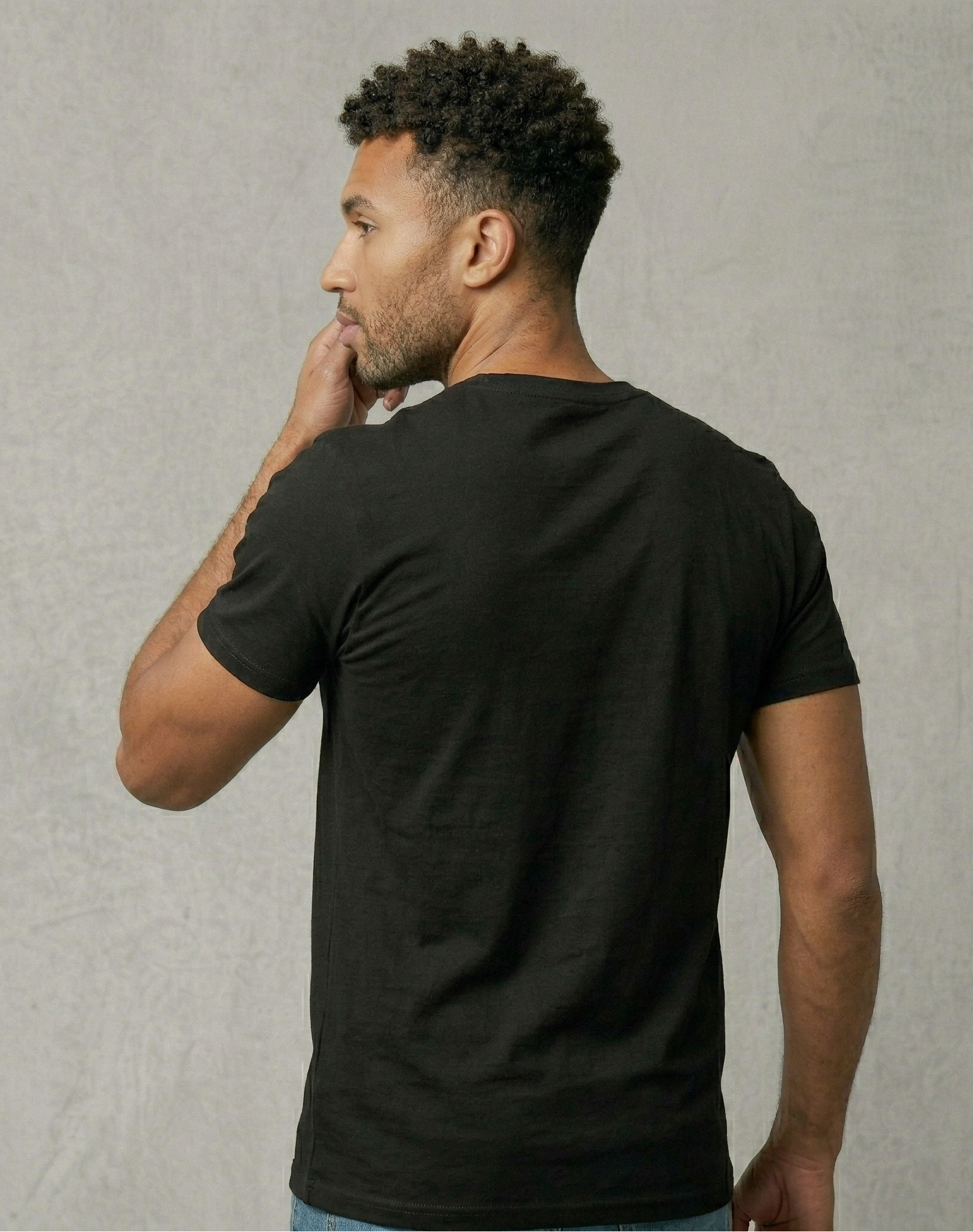 Man wearing a black t-shirt against a plain background