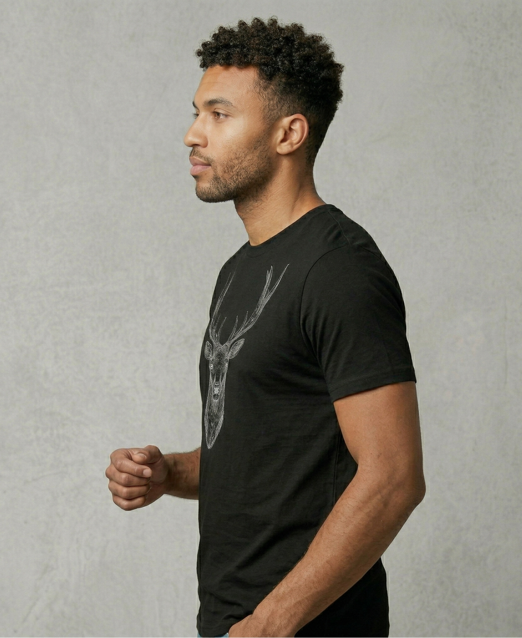 Man wearing a black t-shirt with a graphic design on a gray background